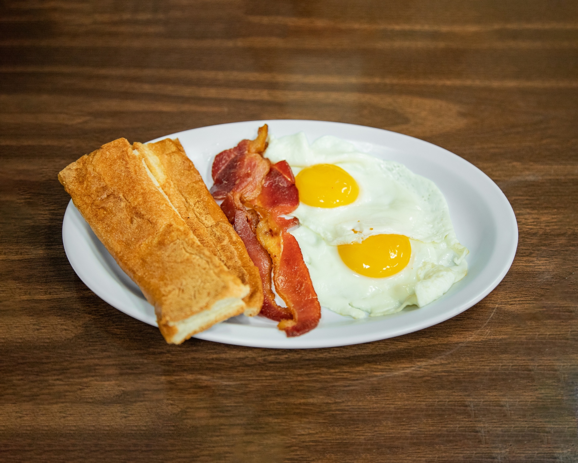 Cafe Caribe breakfast special with two eggs, bacon and Cuban toast